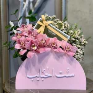 Acrylic box with fresh purple Rose's with green. For Mother of the beloved